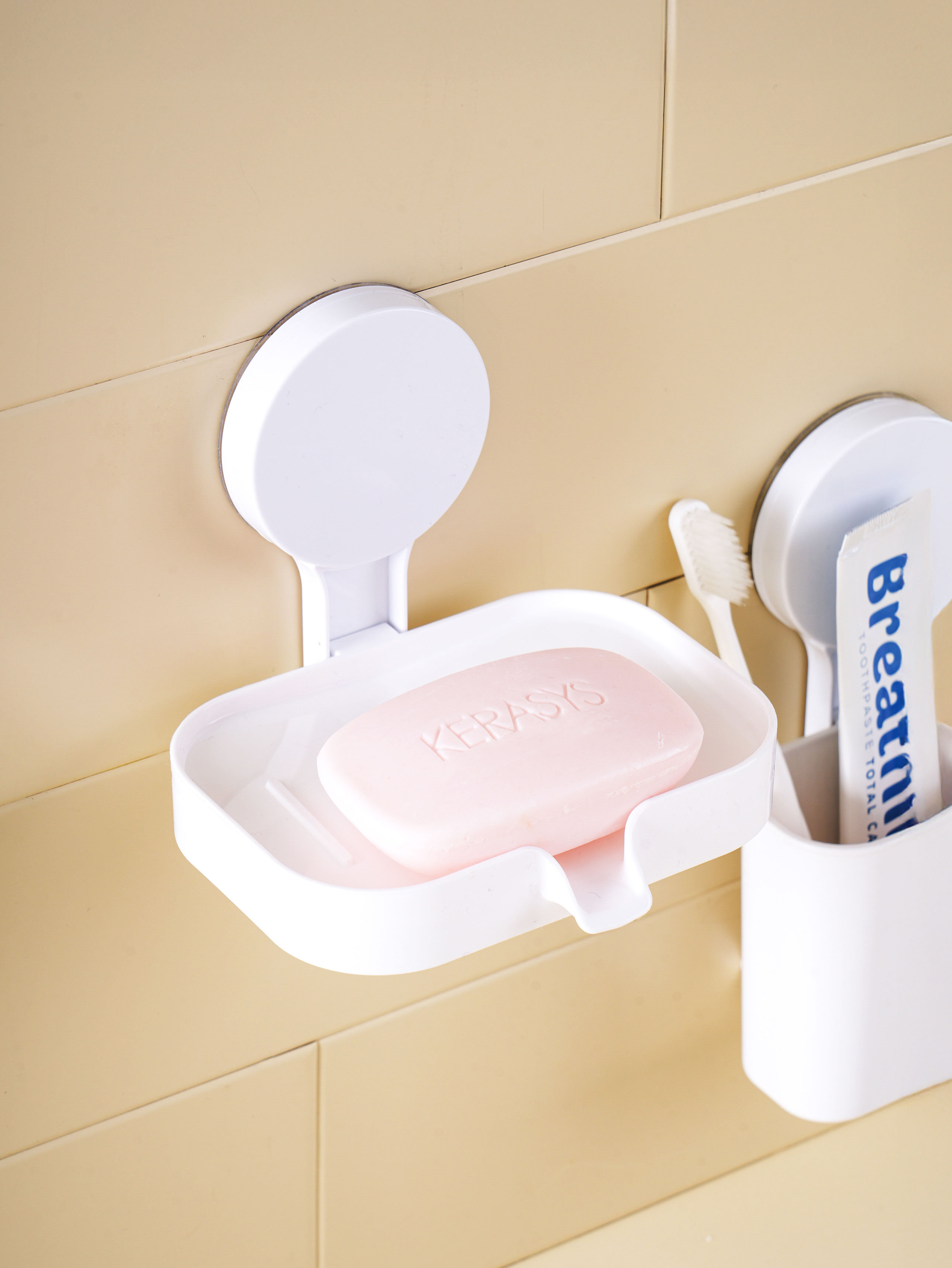 Non-perforated adhesive soap dish
