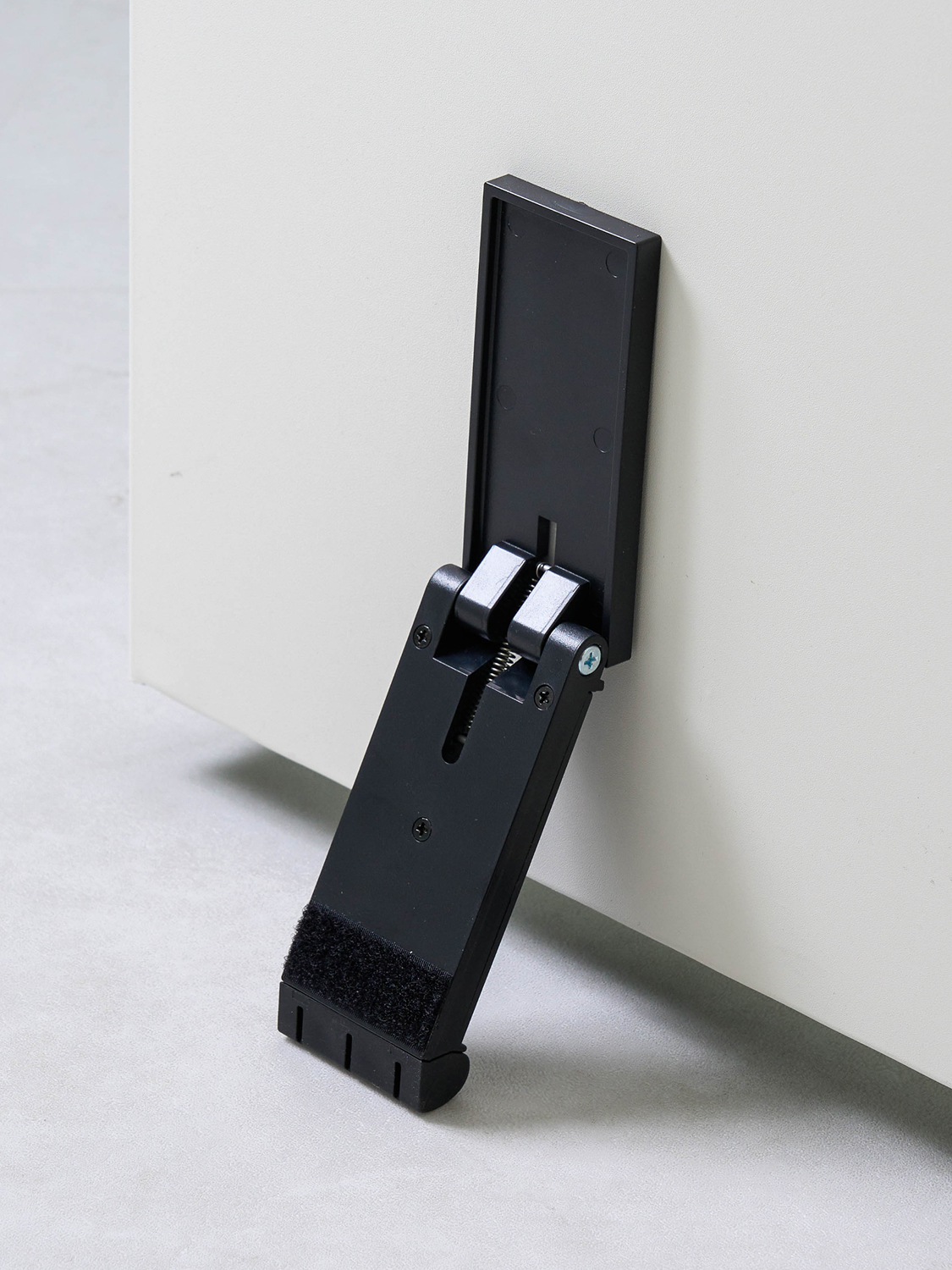 Non-perforated adhesive door stopper