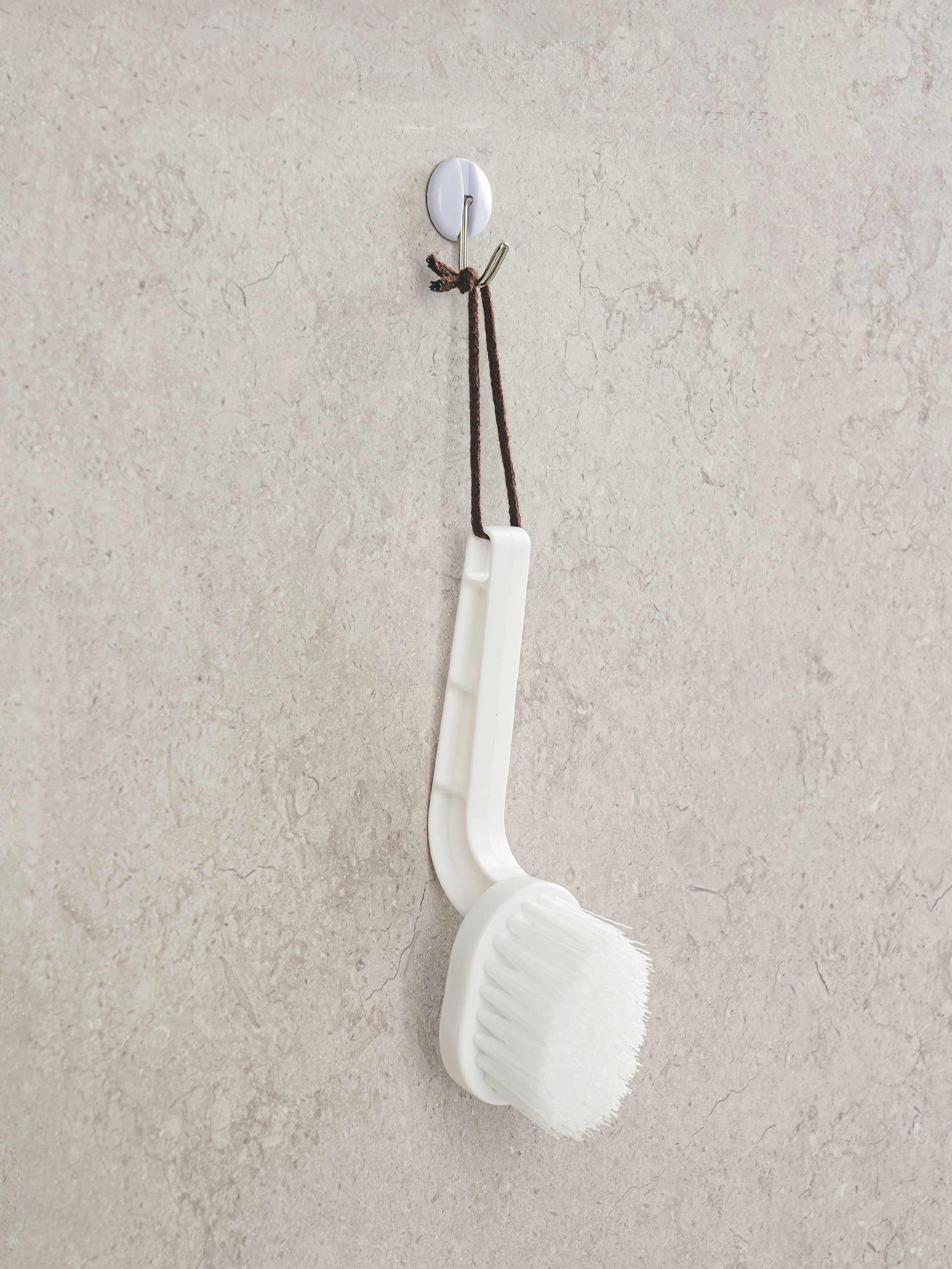 Hanging cleaning brush for bathroom tiles