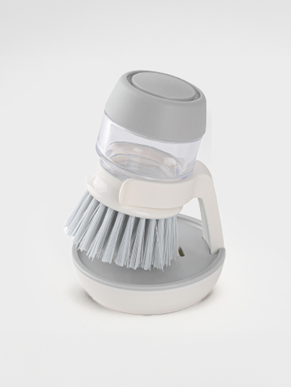 Stationary detergent spray pumping cleaning brush