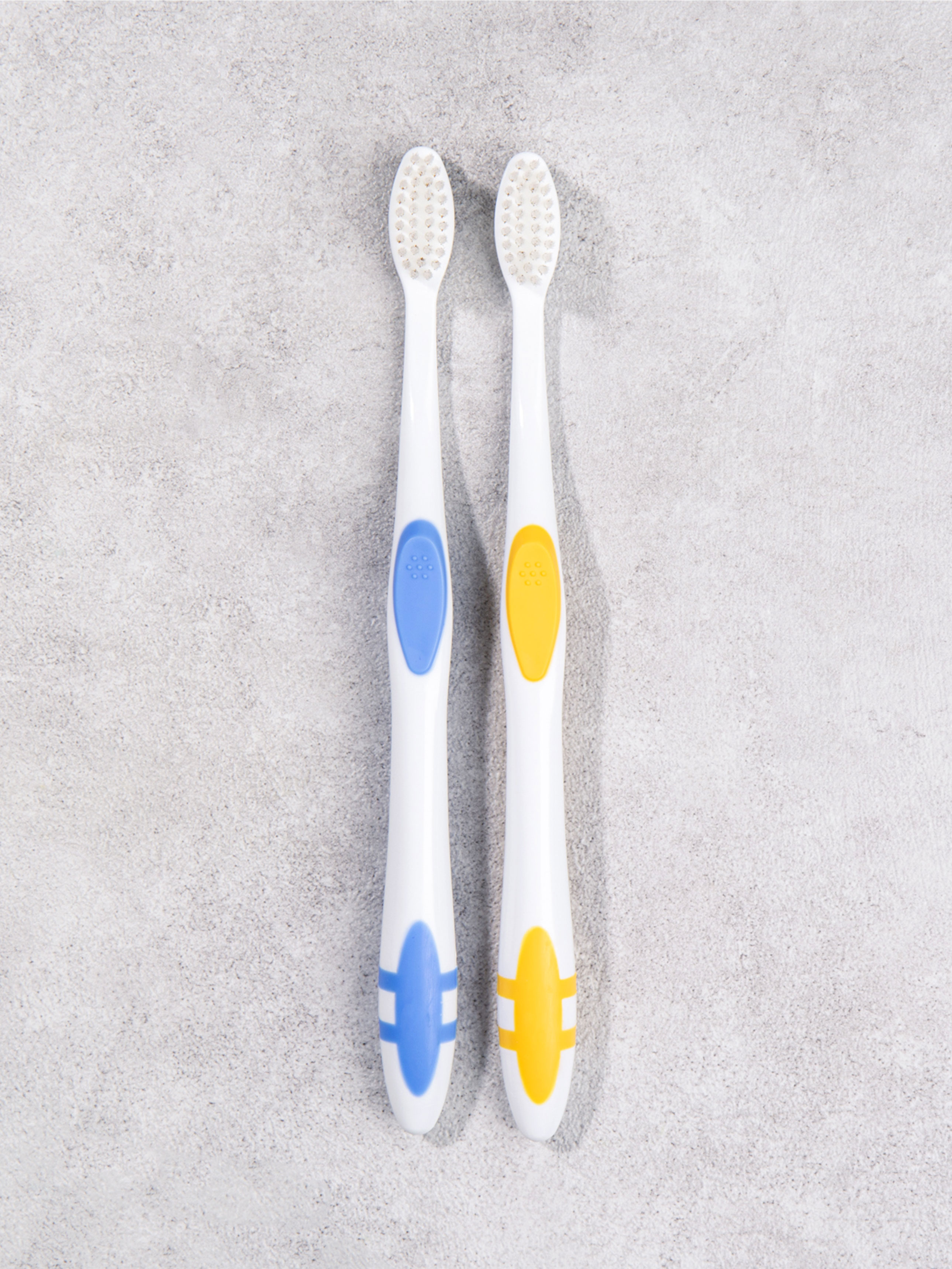 2 adult dental care toothbrushes